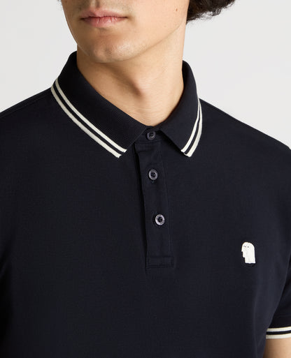 Man wearing a navy Tapered Fit Cotton-Stretch Polo Shirt