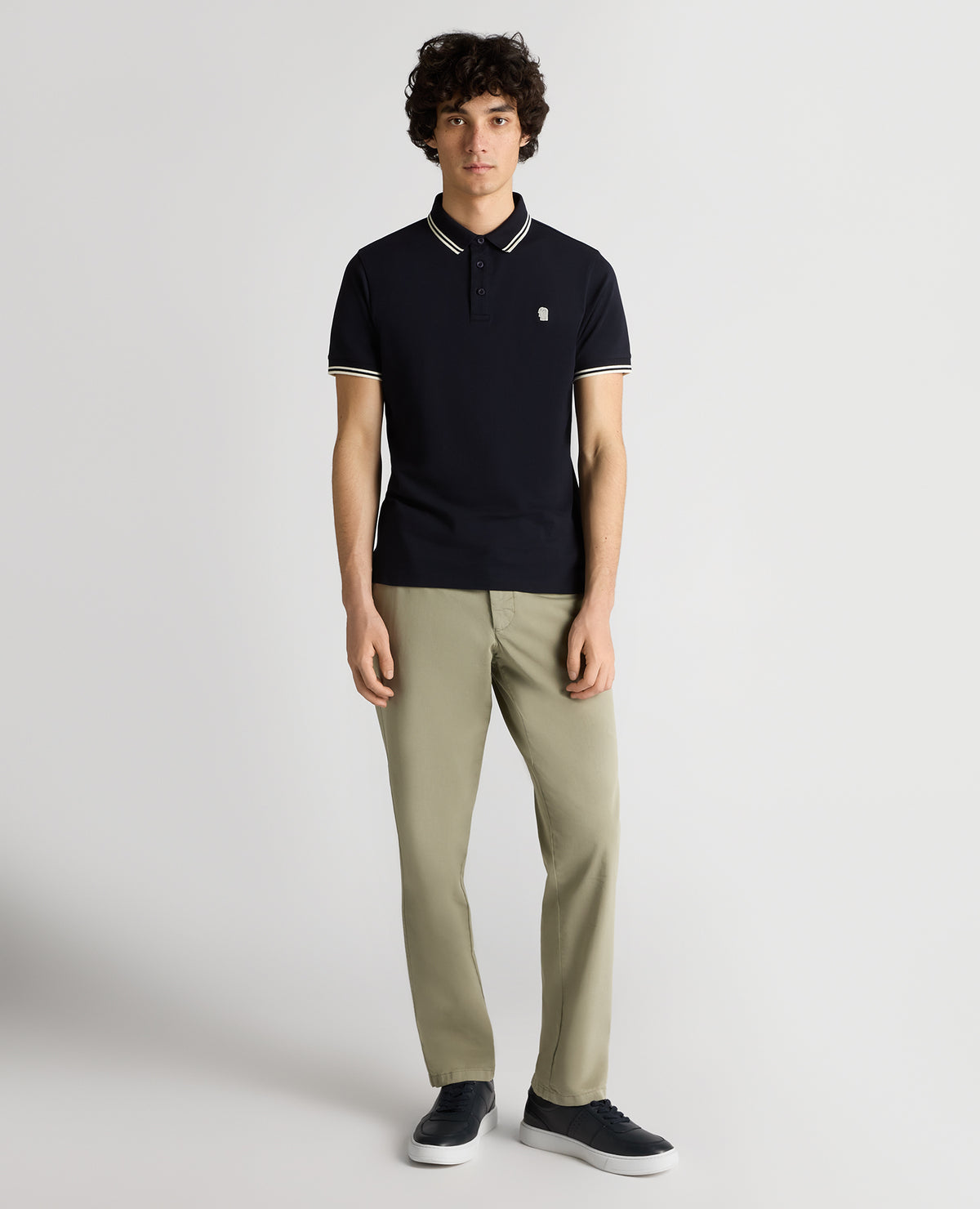 Man wearing a navy Tapered Fit Cotton-Stretch Polo Shirt