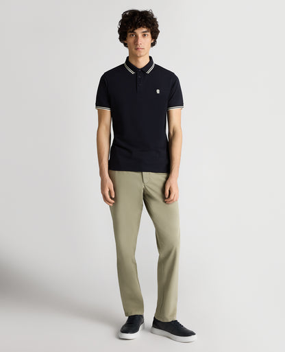 Man wearing a navy Tapered Fit Cotton-Stretch Polo Shirt