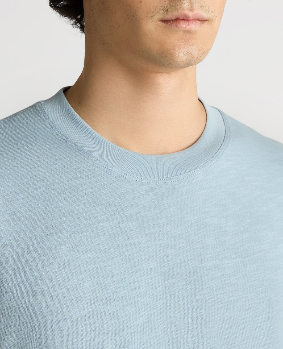 Man wearing a blue Tapered Fit Cotton Crew Neck Tee