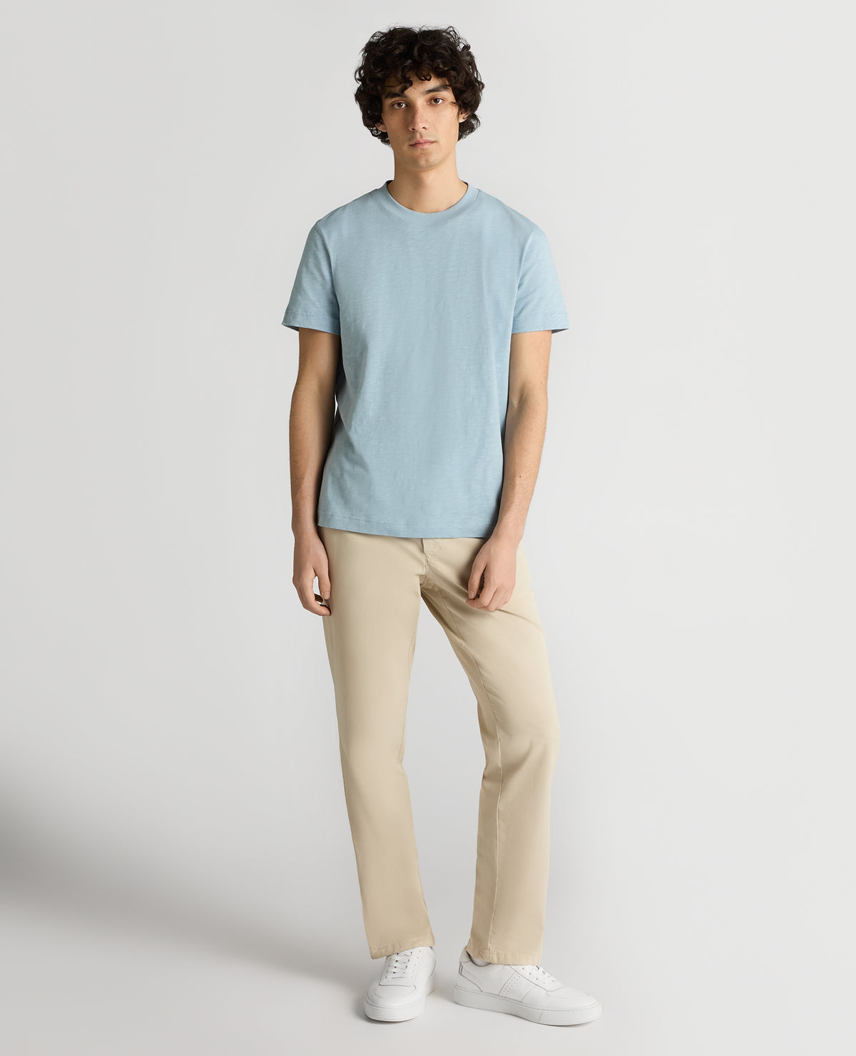 Man wearing a blue Tapered Fit Cotton Crew Neck Tee