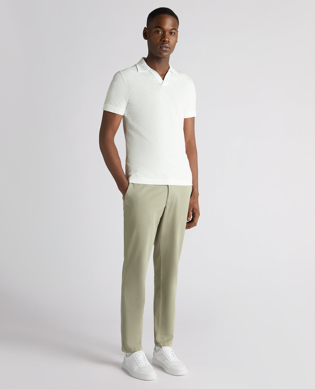 Man wearing a white Tapered Fit Open Collar Cotton Polo
