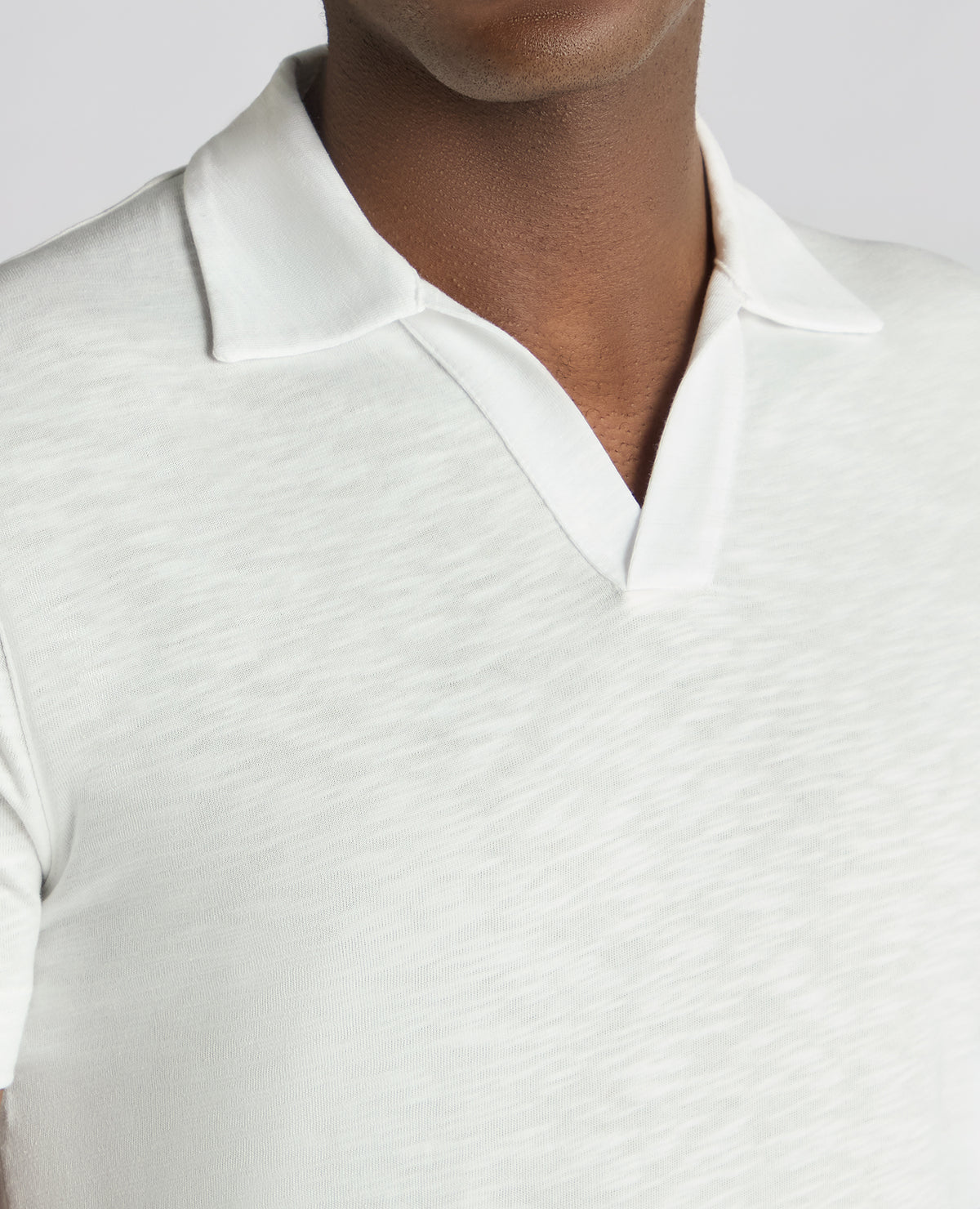 Man wearing a white Tapered Fit Open Collar Cotton Polo
