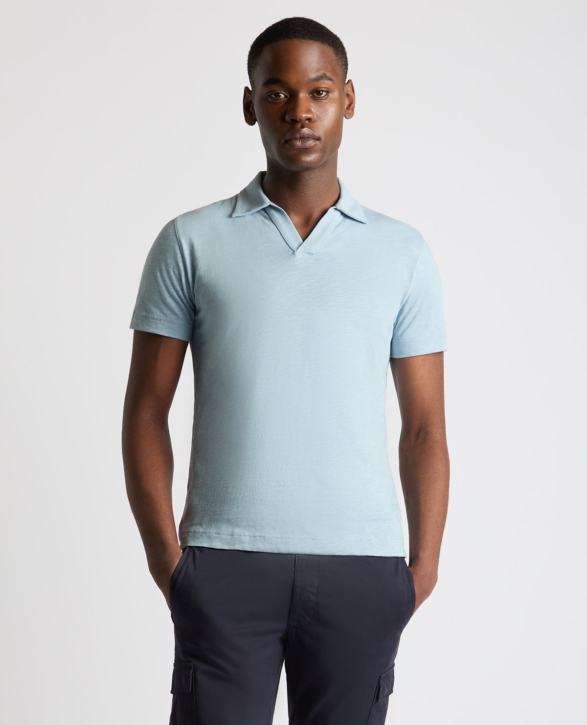 Man wearing a blue Tapered Fit Open Collar Cotton Polo