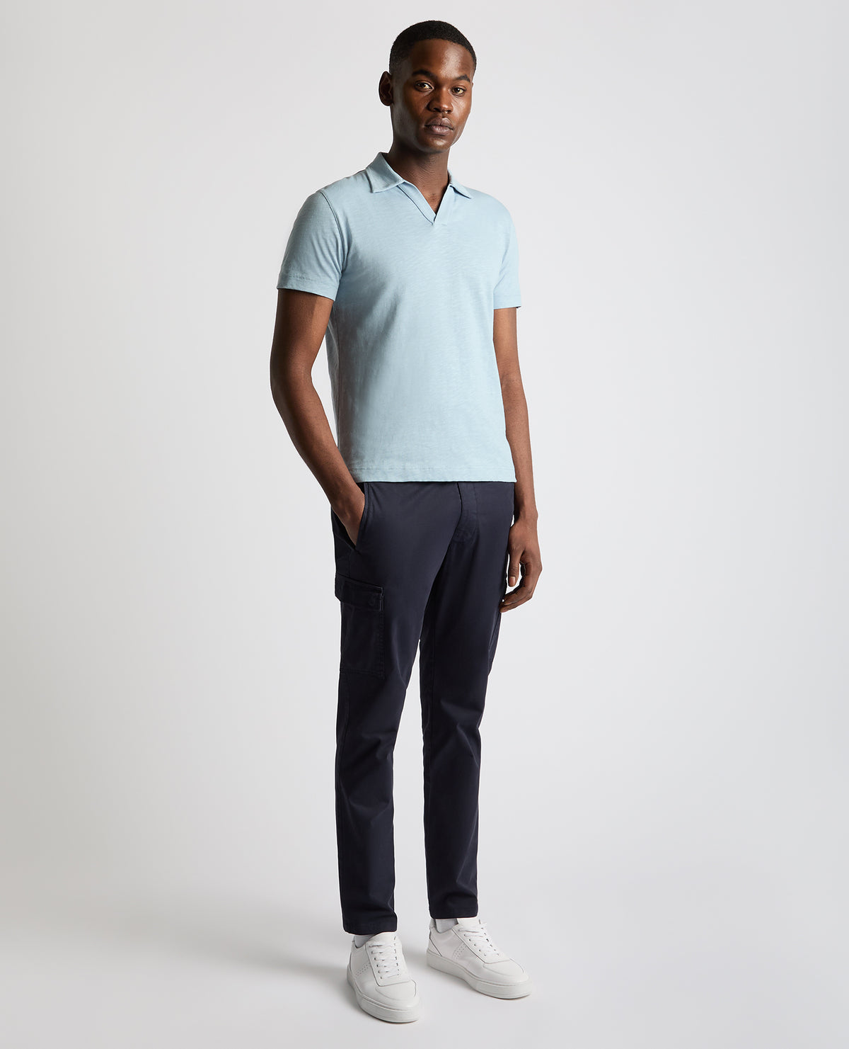 Man wearing a blue Tapered Fit Open Collar Cotton Polo