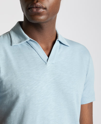 Man wearing a blue Tapered Fit Open Collar Cotton Polo