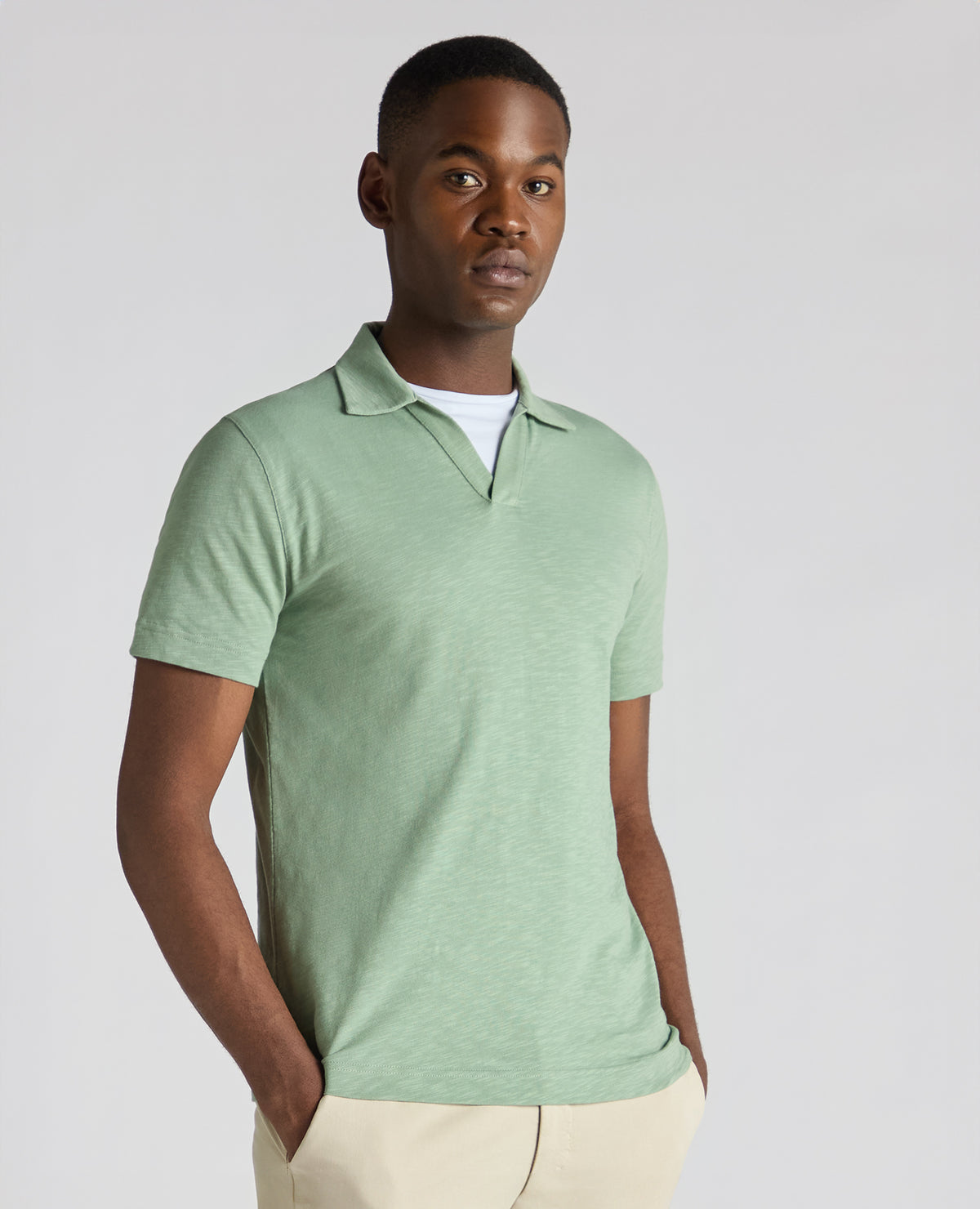 Man wearing a green Tapered Fit Open Collar Cotton Polo