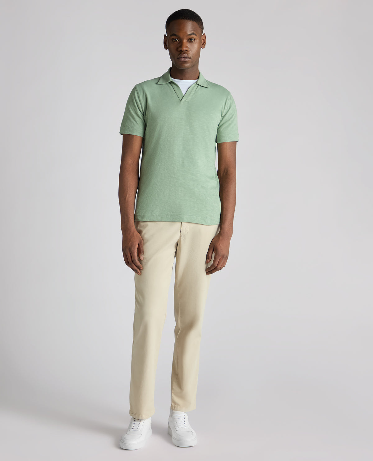 Man wearing a green Tapered Fit Open Collar Cotton Polo
