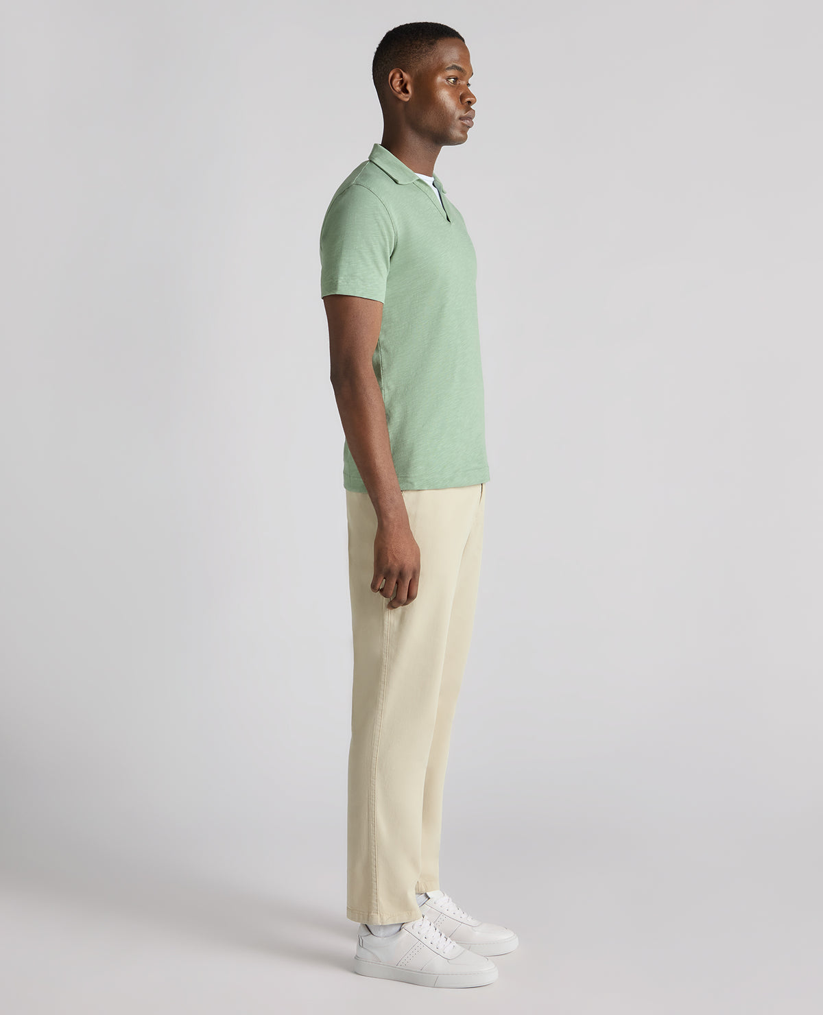 Man wearing a green Tapered Fit Open Collar Cotton Polo