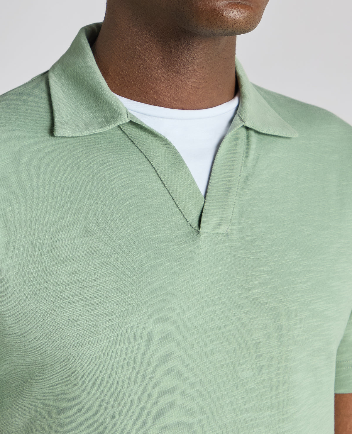 Man wearing a green Tapered Fit Open Collar Cotton Polo