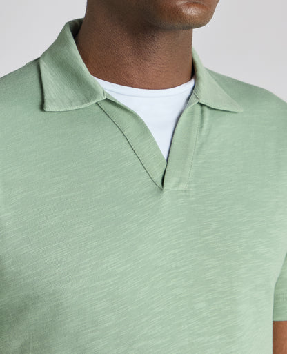Man wearing a green Tapered Fit Open Collar Cotton Polo