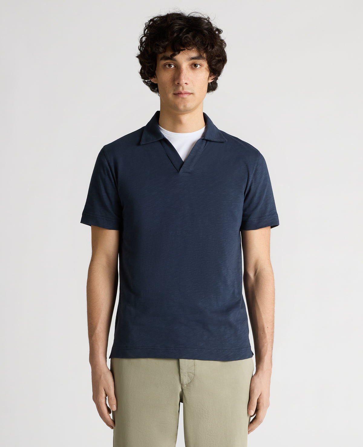 Man wearing a navy Tapered Fit Open Collar Cotton Polo