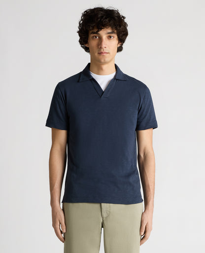 Man wearing a navy Tapered Fit Open Collar Cotton Polo