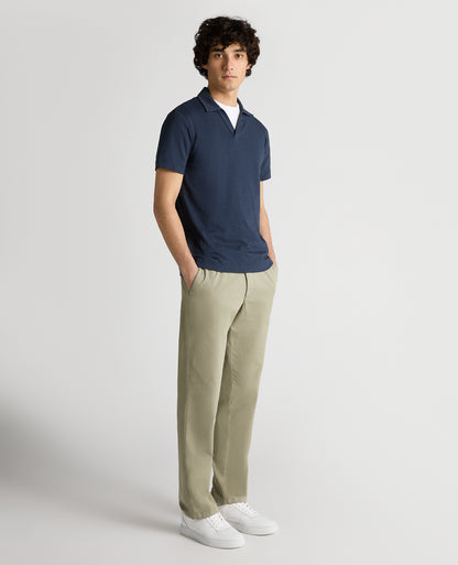 Man wearing a navy Tapered Fit Open Collar Cotton Polo