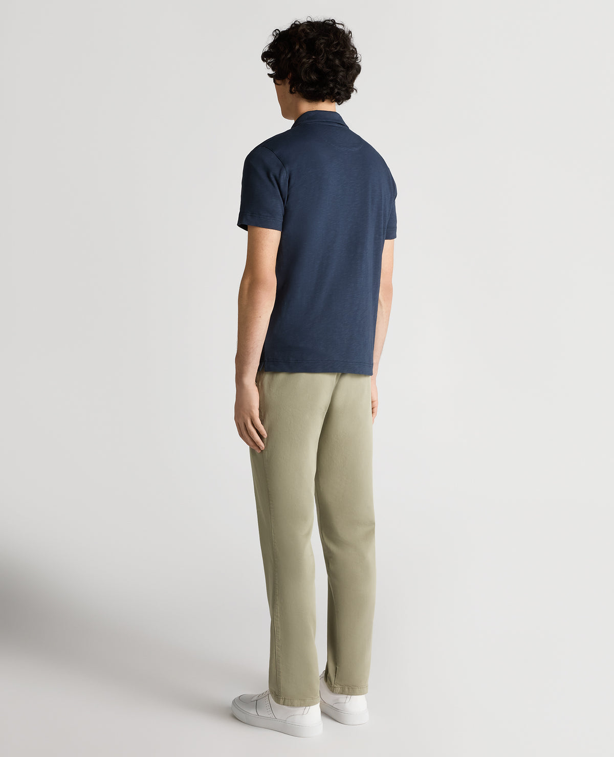 Man wearing a navy Tapered Fit Open Collar Cotton Polo