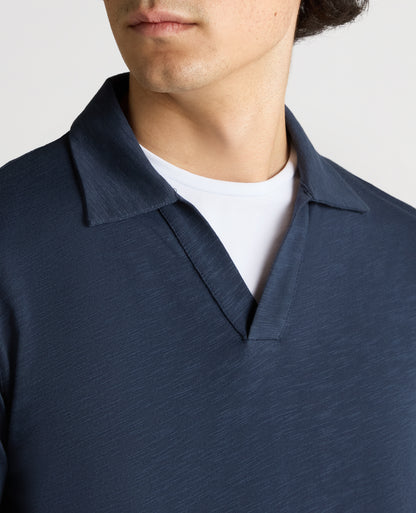 Man wearing a navy Tapered Fit Open Collar Cotton Polo