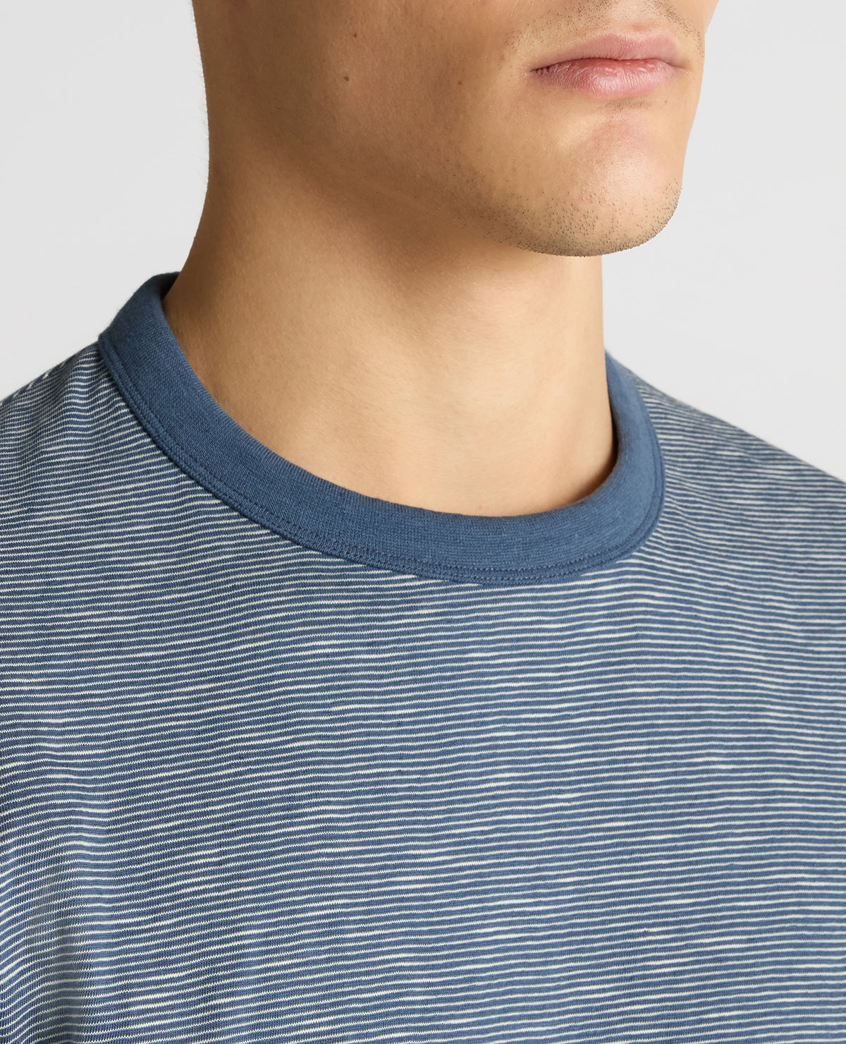 Man wearing a blue Tapered Fit Cotton-Linen T-Shirt