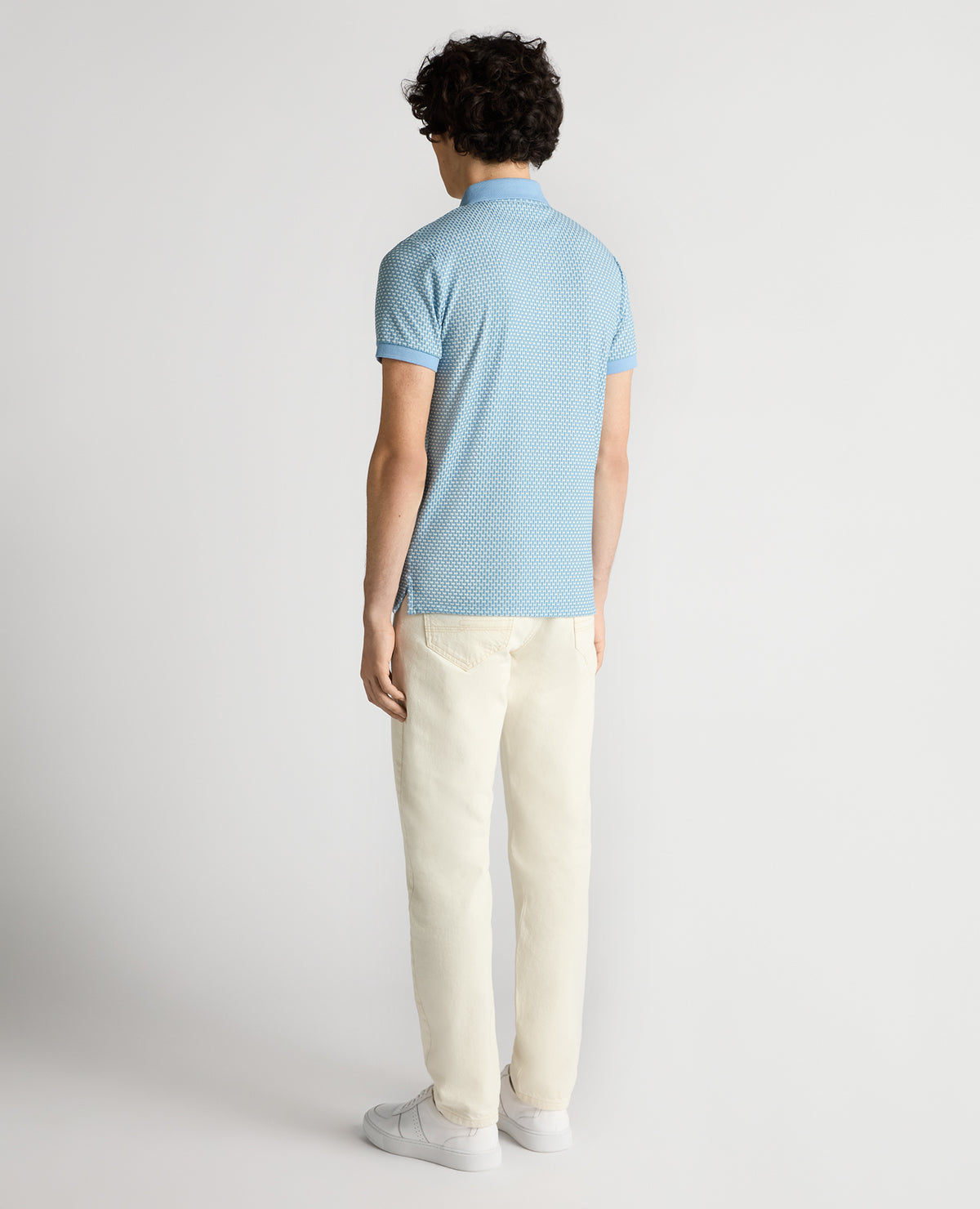 Man wearing a blue Tapered Fit Basket Weave Polo Shirt