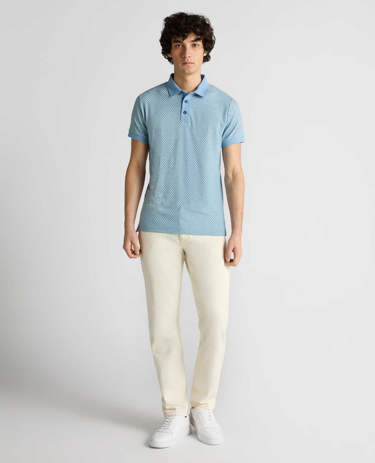 Man wearing a blue Tapered Fit Basket Weave Polo Shirt