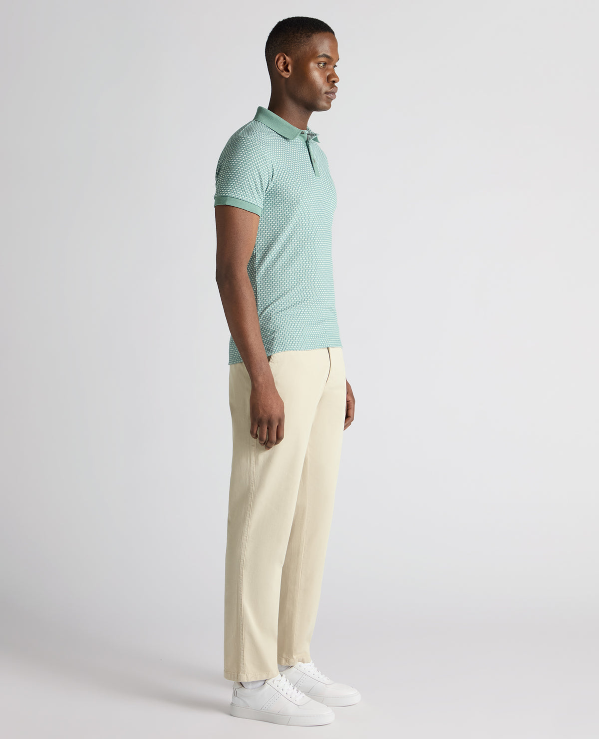 Man wearing a green Tapered Fit Cotton-Blend Polo Shirt