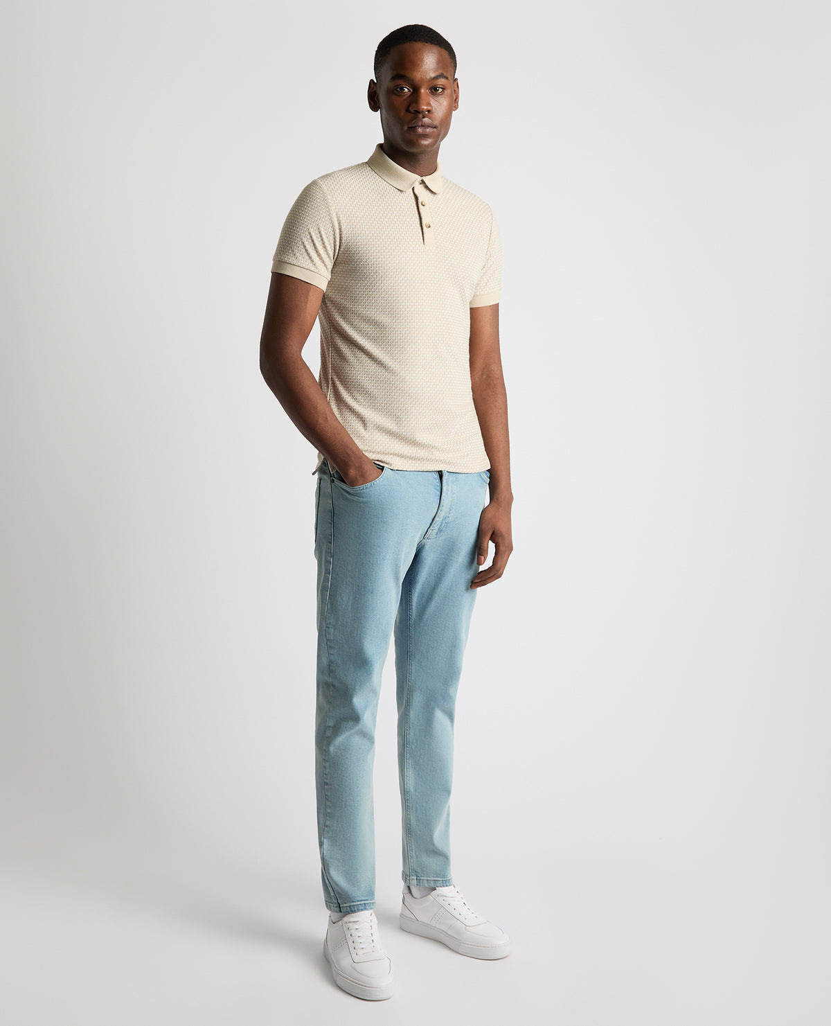 Man wearing a sand Tapered Fit Cotton-Blend Polo Shirt