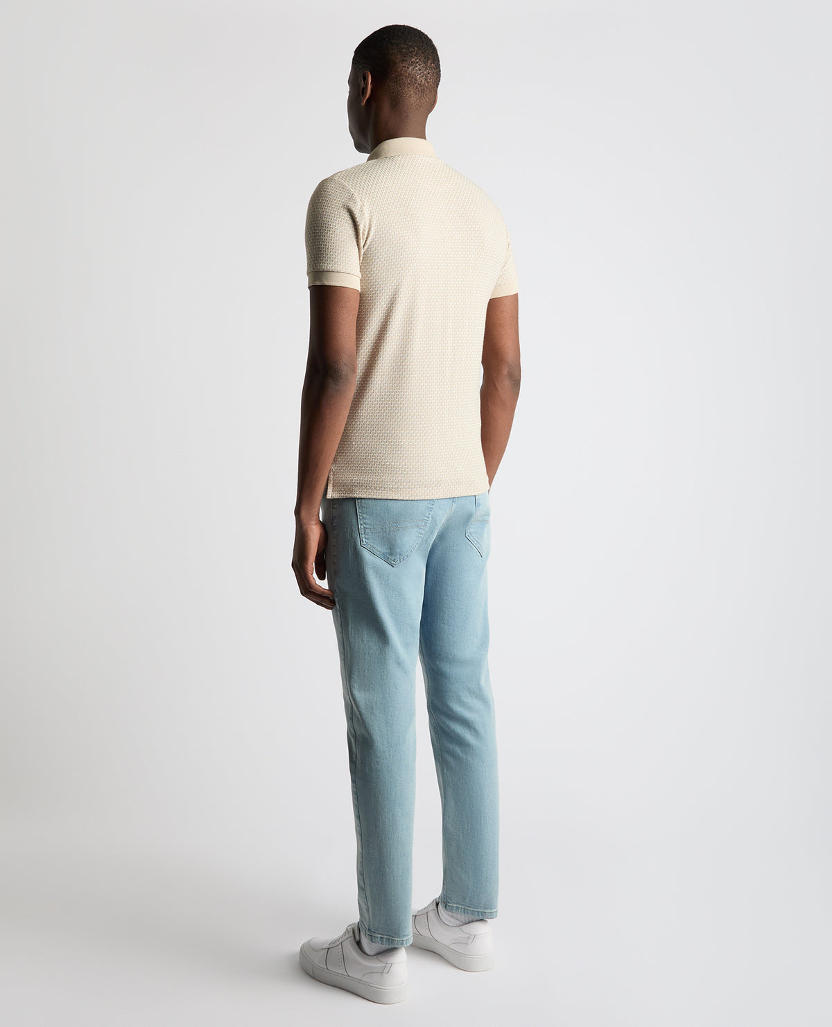 Man wearing a sand Tapered Fit Cotton-Blend Polo Shirt