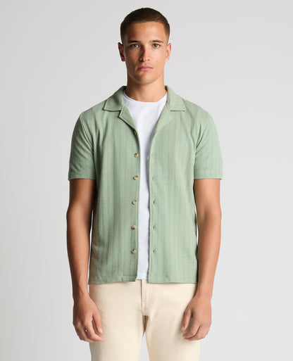 Man wearing a green Relaxed Fit Cotton-Linen Cuban Collar Shirt