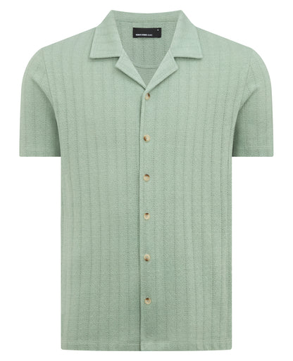 Man wearing a green Relaxed Fit Cotton-Linen Cuban Collar Shirt