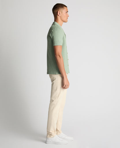 Man wearing a green Relaxed Fit Cotton-Linen Cuban Collar Shirt