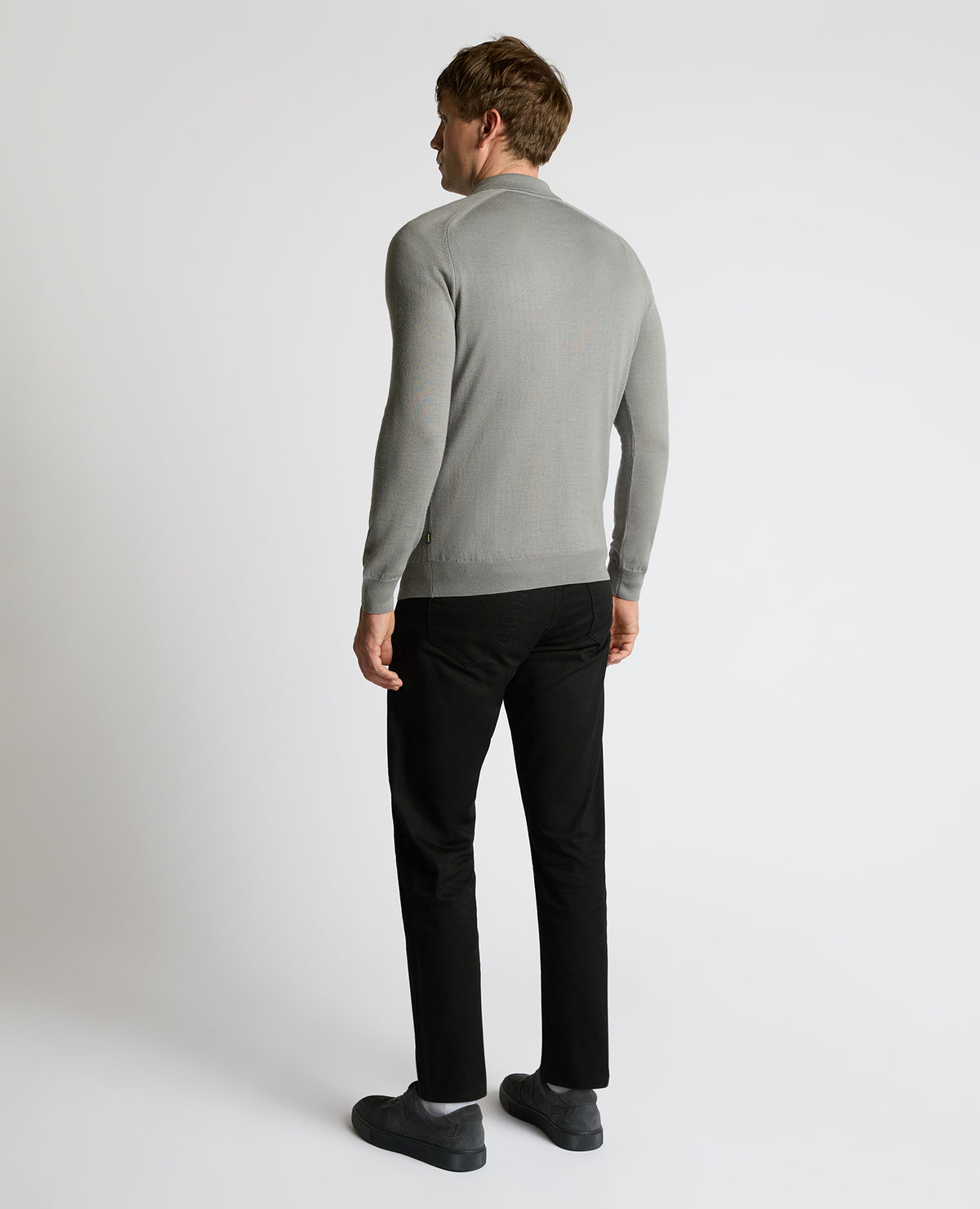 Man wearing a grey Merino Wool-Blend Knit Polo