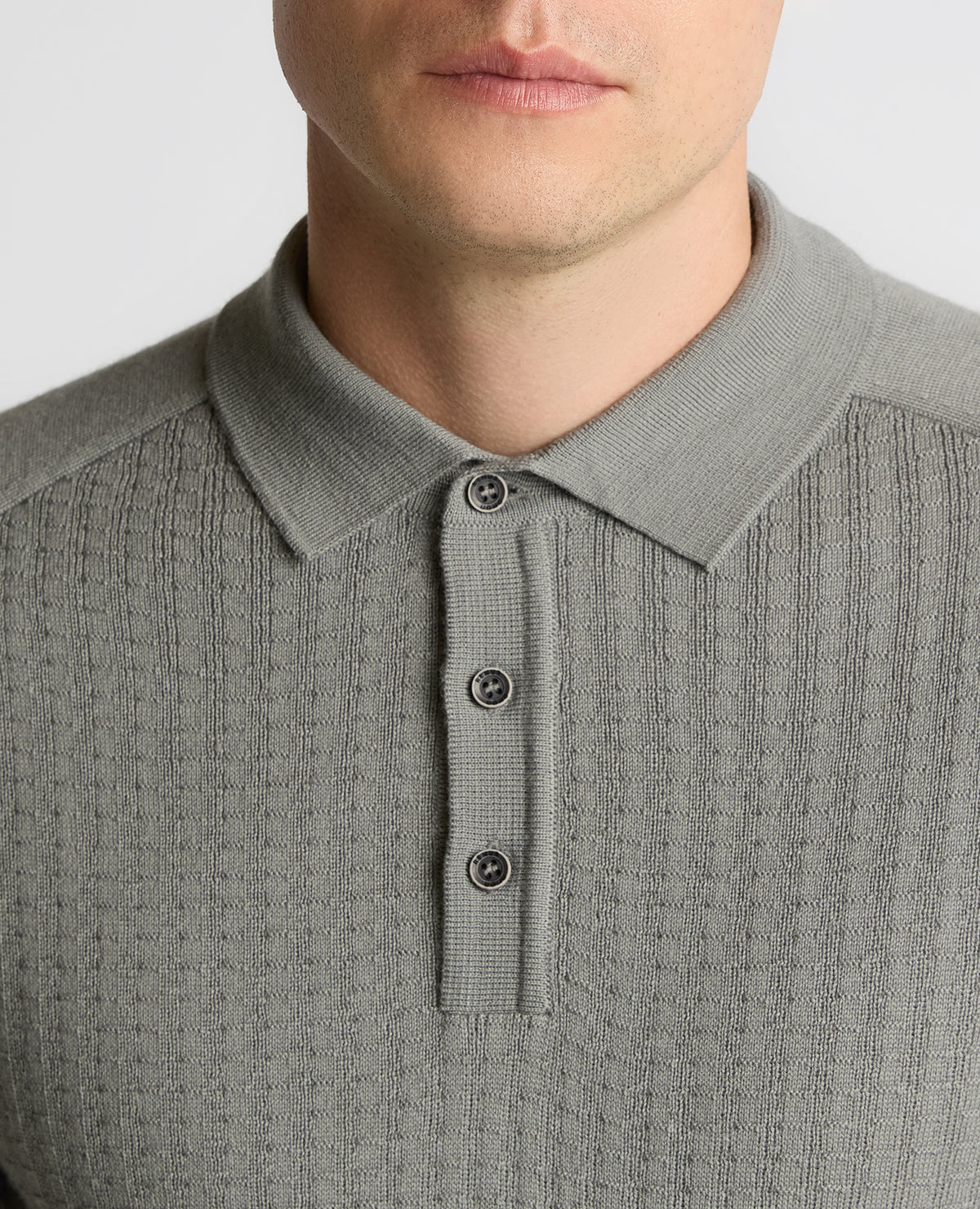 Man wearing a grey Merino Wool-Blend Knit Polo