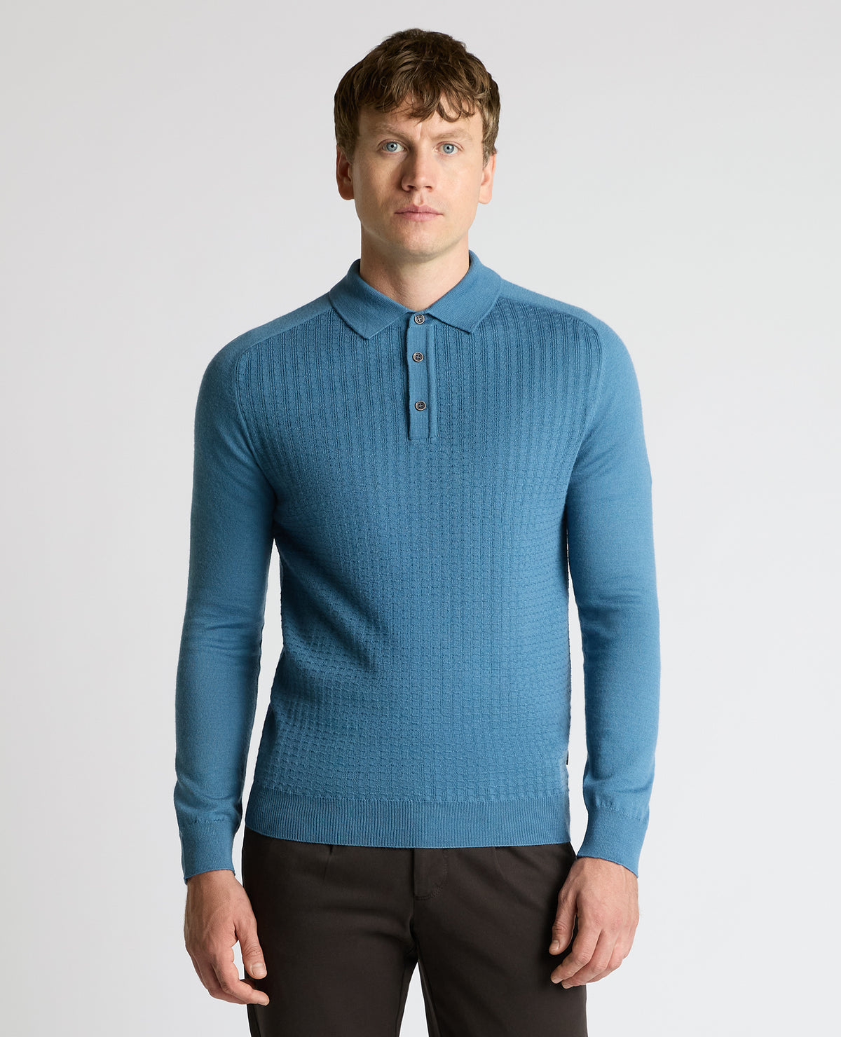 Man wearing a blue Merino Wool-Blend Knit Polo