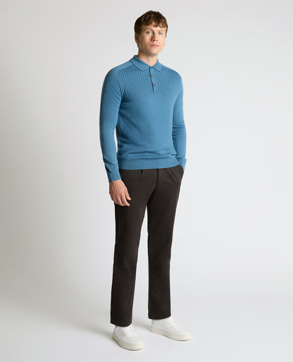 Man wearing a blue Merino Wool-Blend Knit Polo