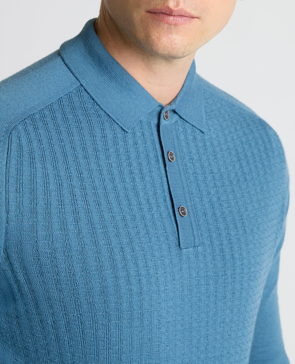 Man wearing a blue Merino Wool-Blend Knit Polo
