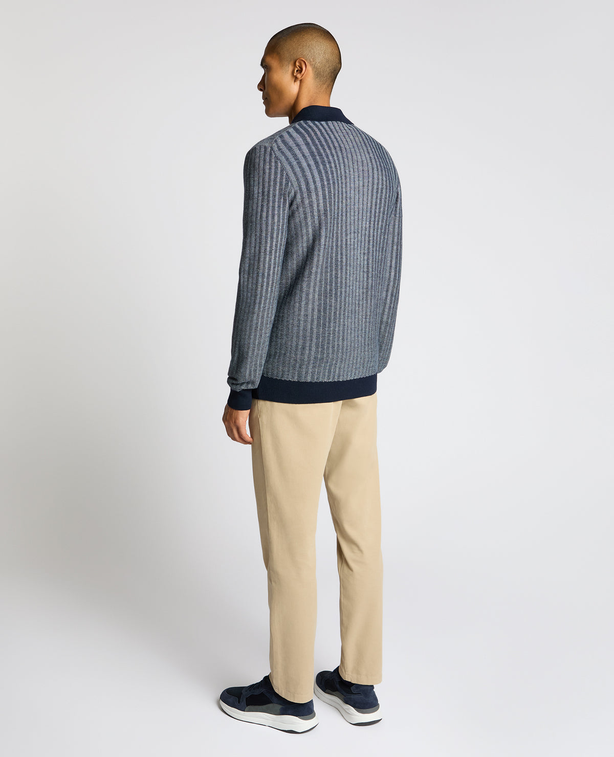 Man wearing a blue Plaited Stripe Wool-Blend Knit Polo
