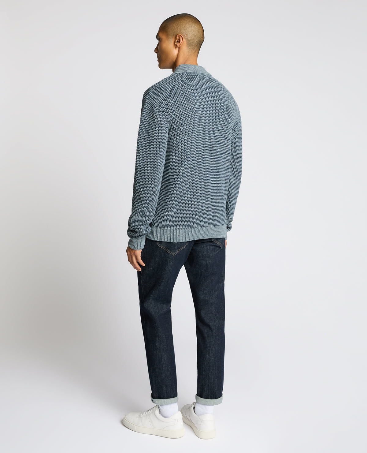 Man wearing a blue Cotton Knit Polo Sweater
