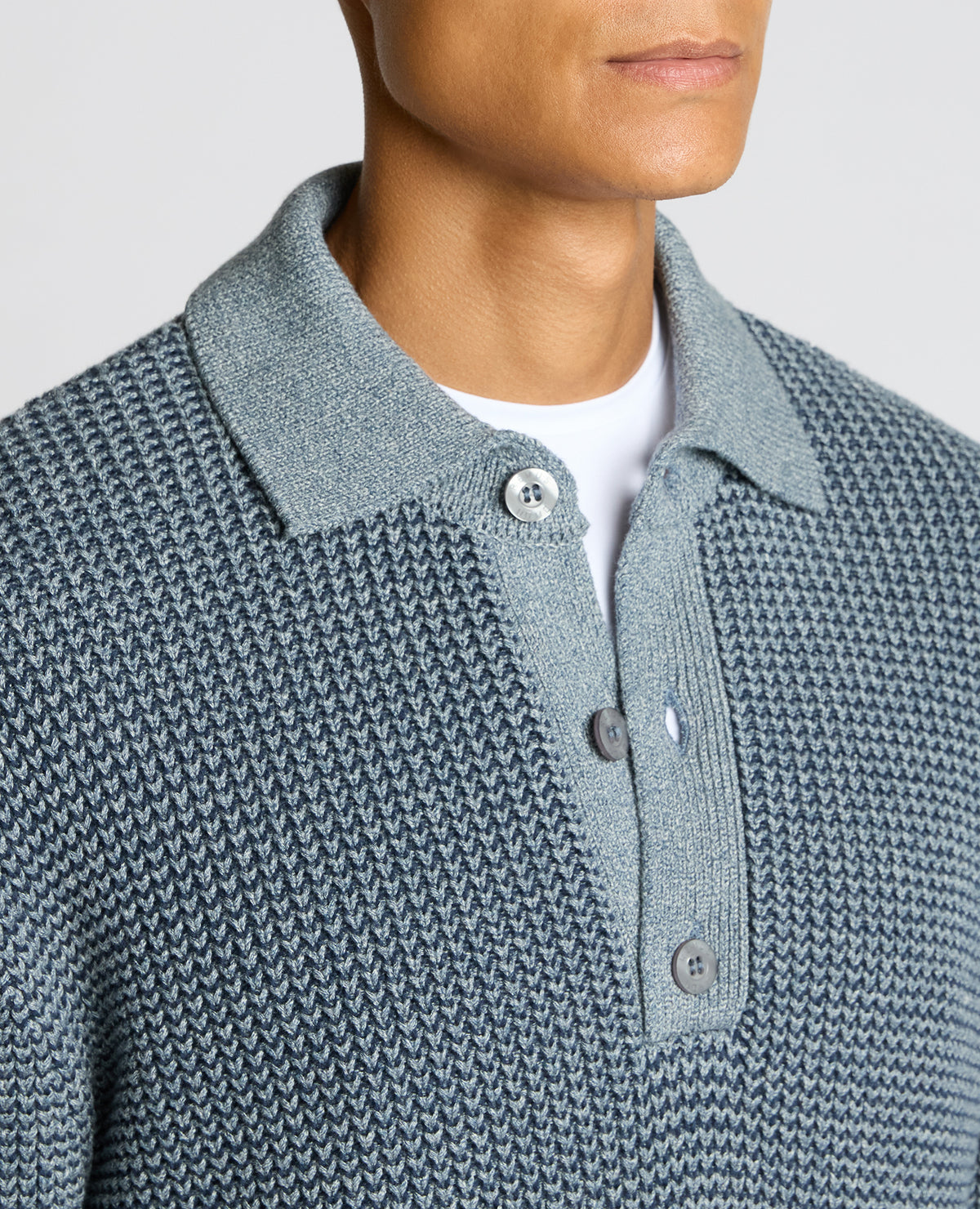 Man wearing a blue Cotton Knit Polo Sweater