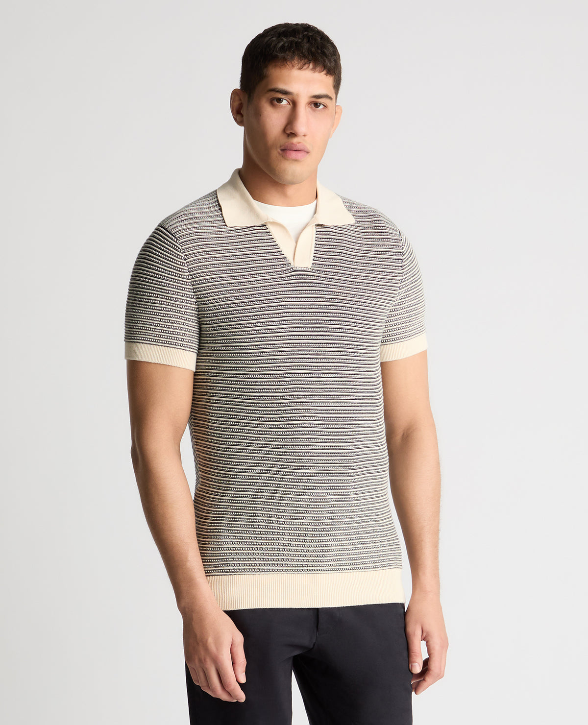 Man wearing a white and navy jumper