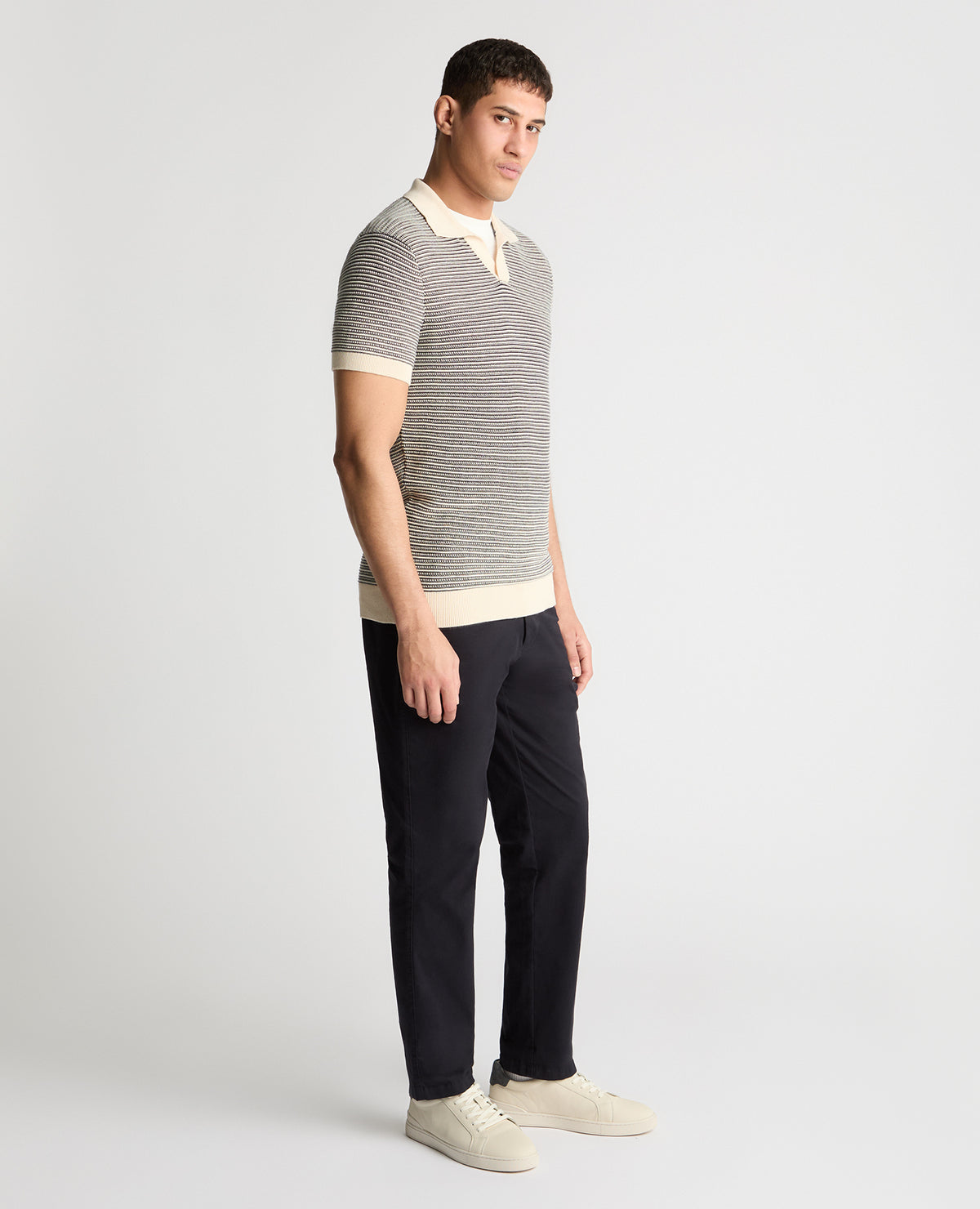 Man wearing a white and navy jumper