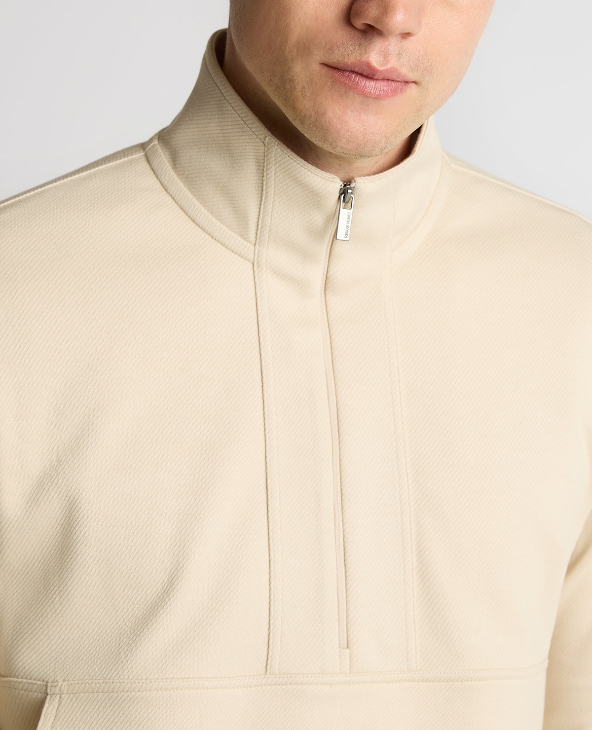 Man wearing a sand Half-Zip Jersey Sweatshirt