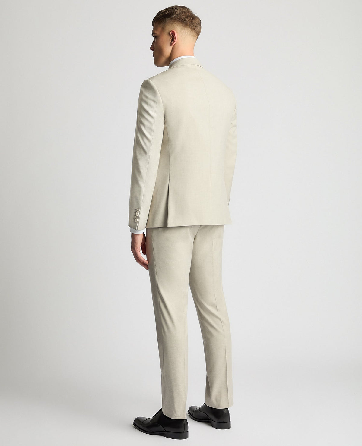 Man wearing a sand Tapered Fit Stretch Suit