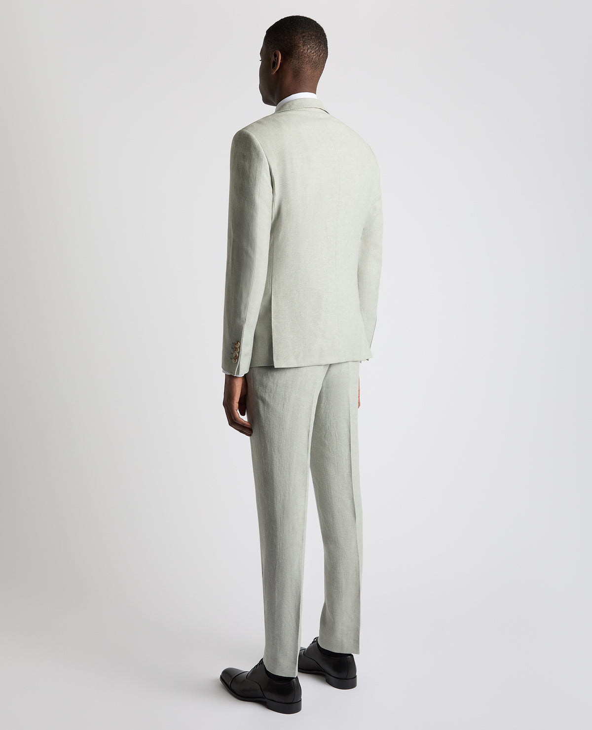 Man wearing a green Tapered Fit Linen-Blend Suit