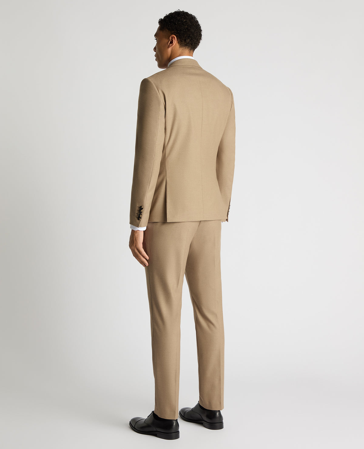 Man wearing a sand Slim Fit Stretch Suit Jacket