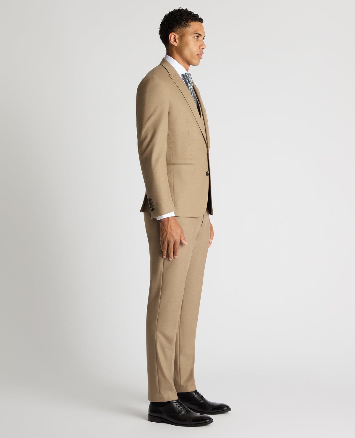 Man wearing a sand Slim Fit Stretch Suit Jacket