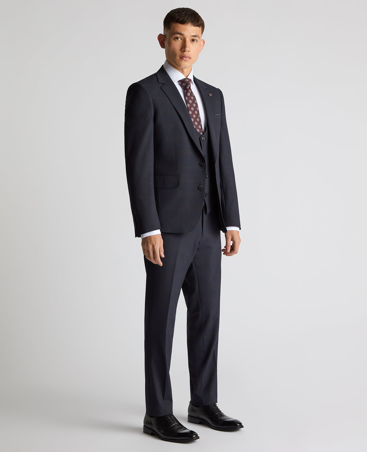 Man wearing a navy Slim Fit Checked Stretch Suit
