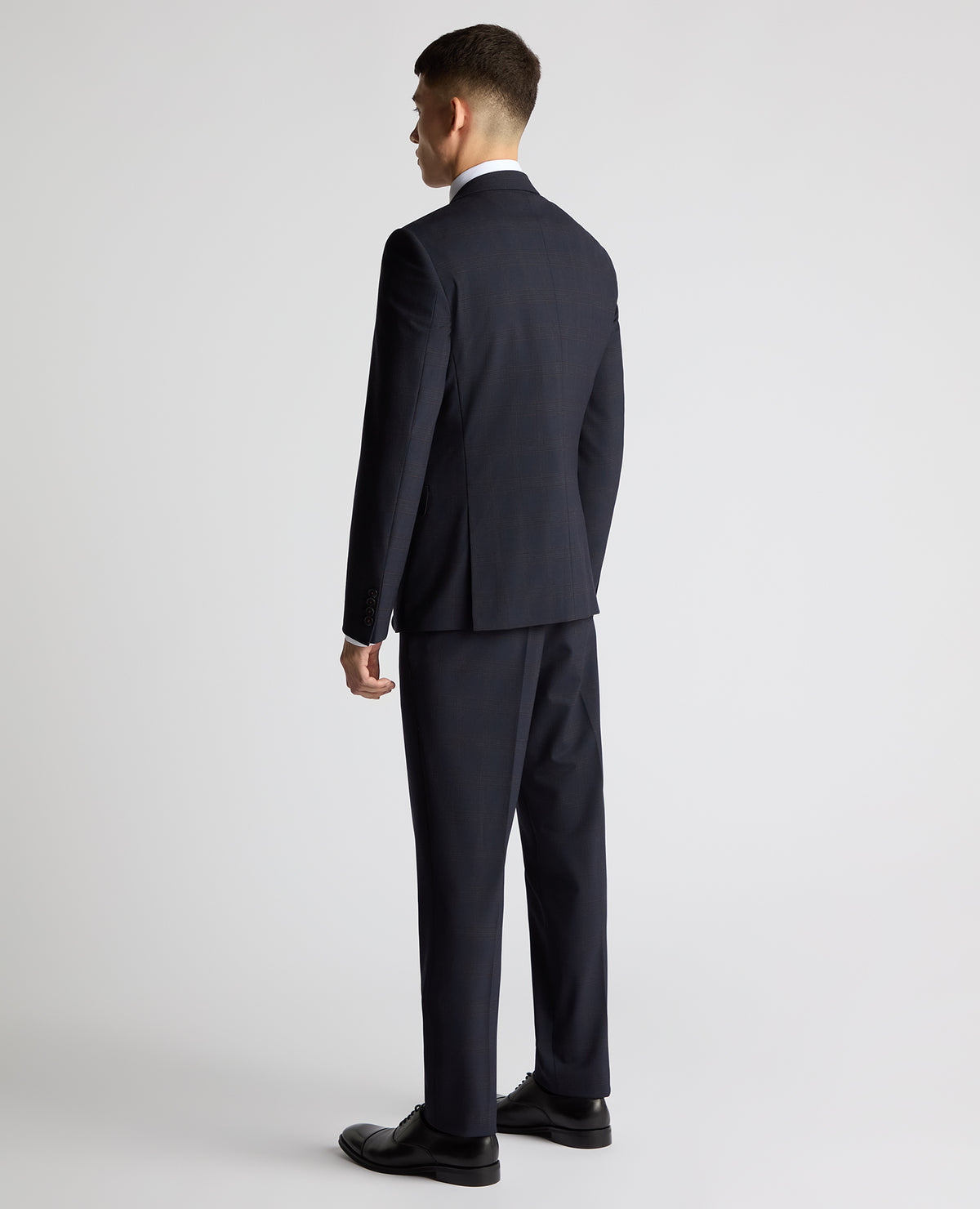 Man wearing a navy Slim Fit Checked Stretch Suit
