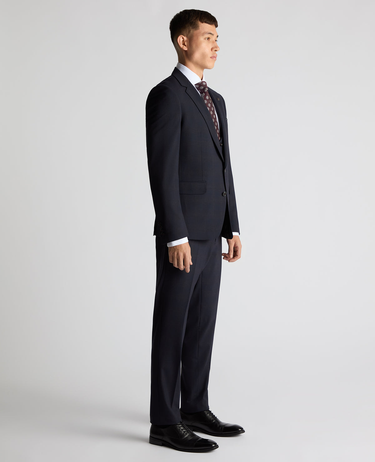 Man wearing a navy Slim Fit Checked Stretch Suit