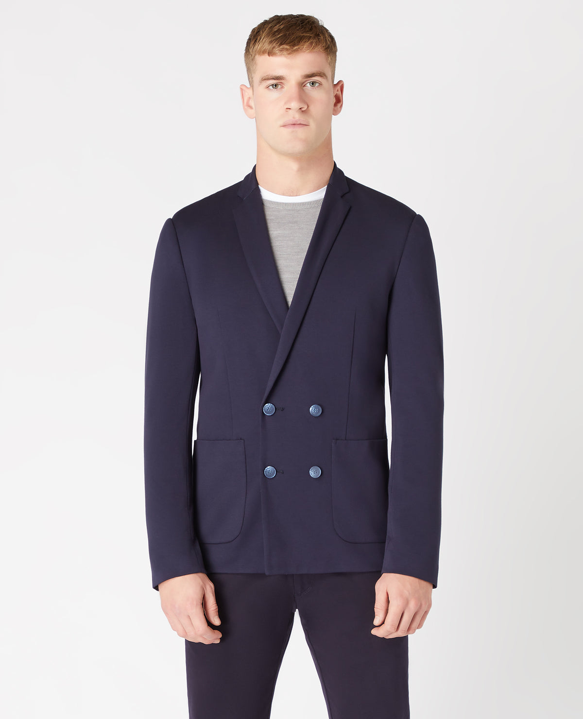 Man wearing a navy Slim Fit Double Breasted Stretch Jersey Jacket