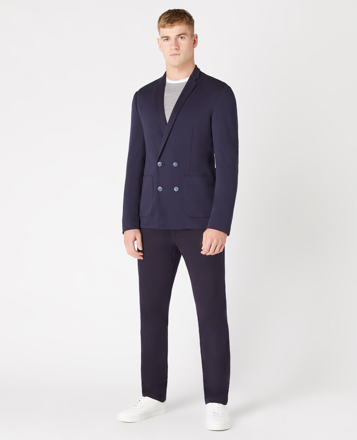 Man wearing a navy Slim Fit Double Breasted Stretch Jersey Jacket