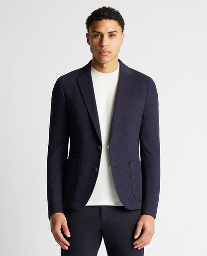 Man wearing a navy Slim Fit Cotton-Blend Stretch Jacket